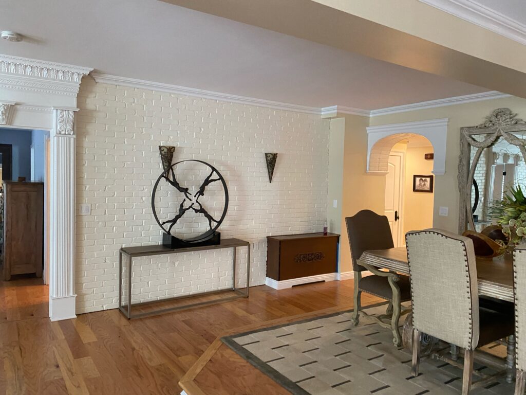 Classic style interior with a unique clock and a painted brick wall design.