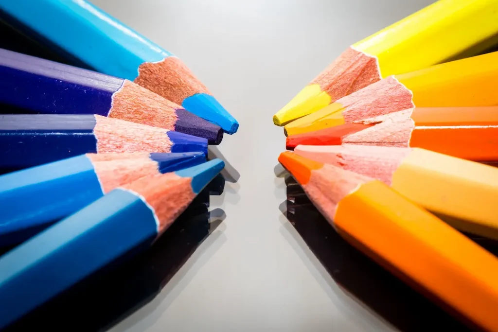 Cool vs Warm Colored Pencils pointed at each other
