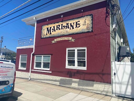 The exterior of a retail location, painted in a bright & very solid red coat of paint