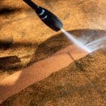 Carfagno team member power washing a dirty residential floor in ocean county nj