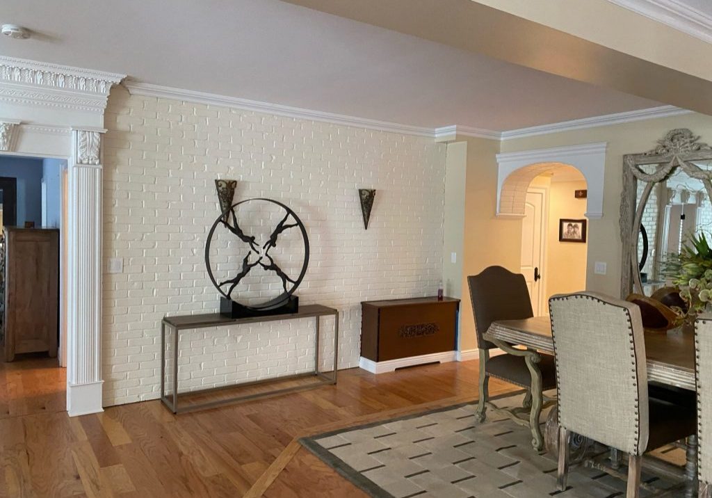 Classic style interior with a unique clock and a painted brick wall design.